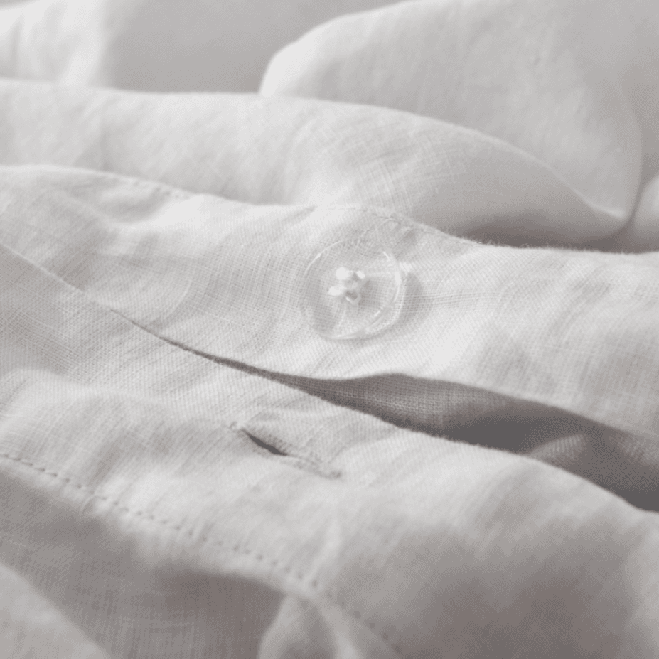 Close-up of a textured white fabric with a button
