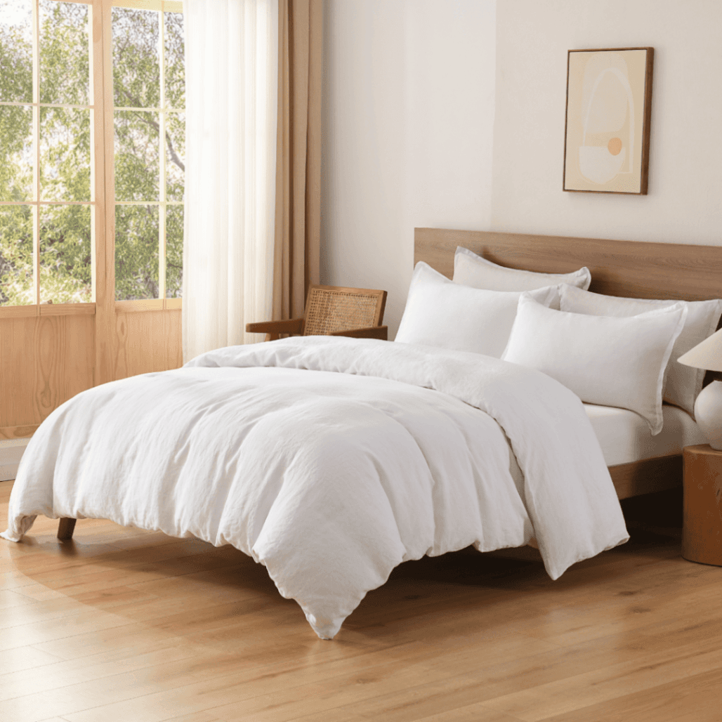 Neatly made bed with white bedding in a bright bedroom