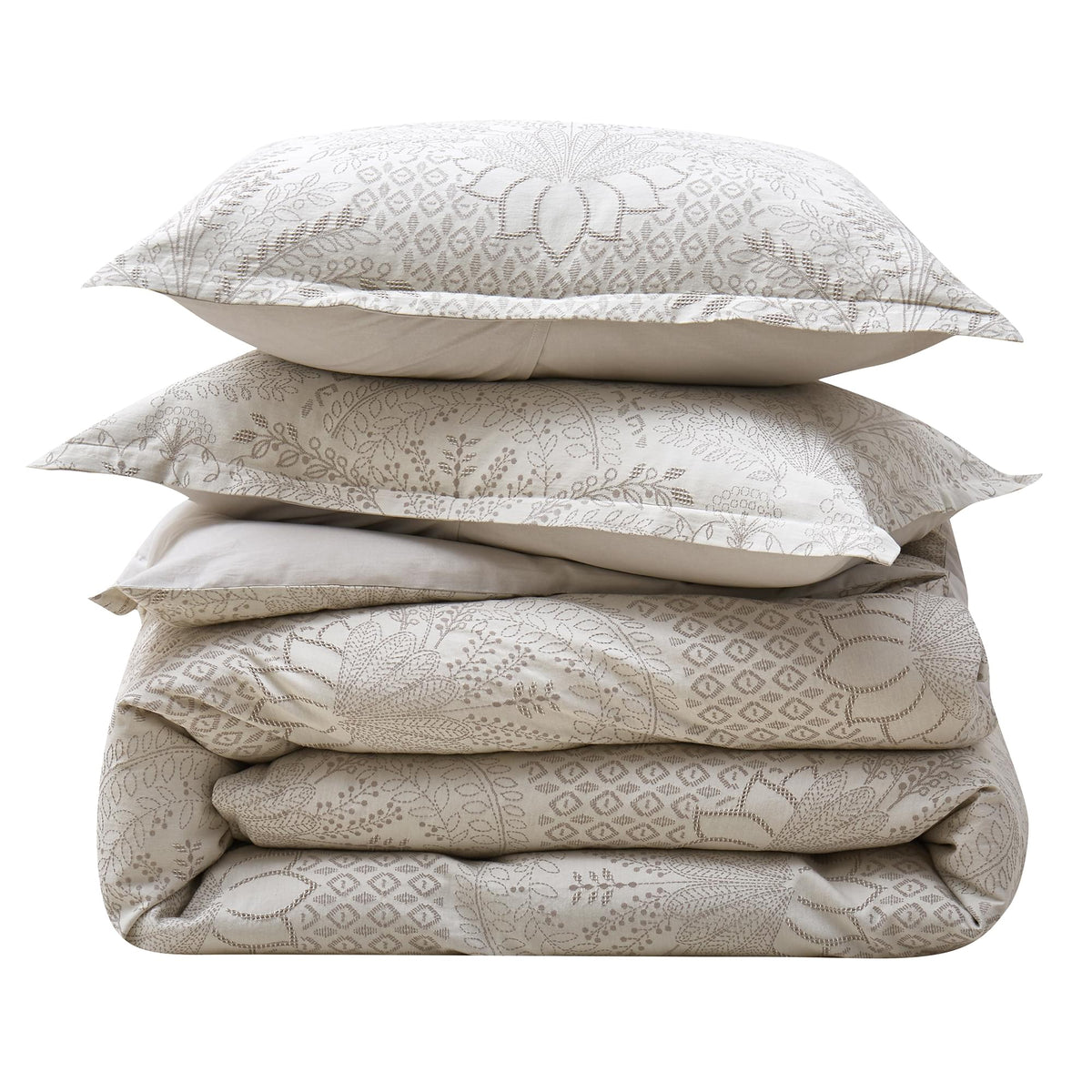 Stack of beige Timeless Heritage Woven Comforter Set with pillows on a white background