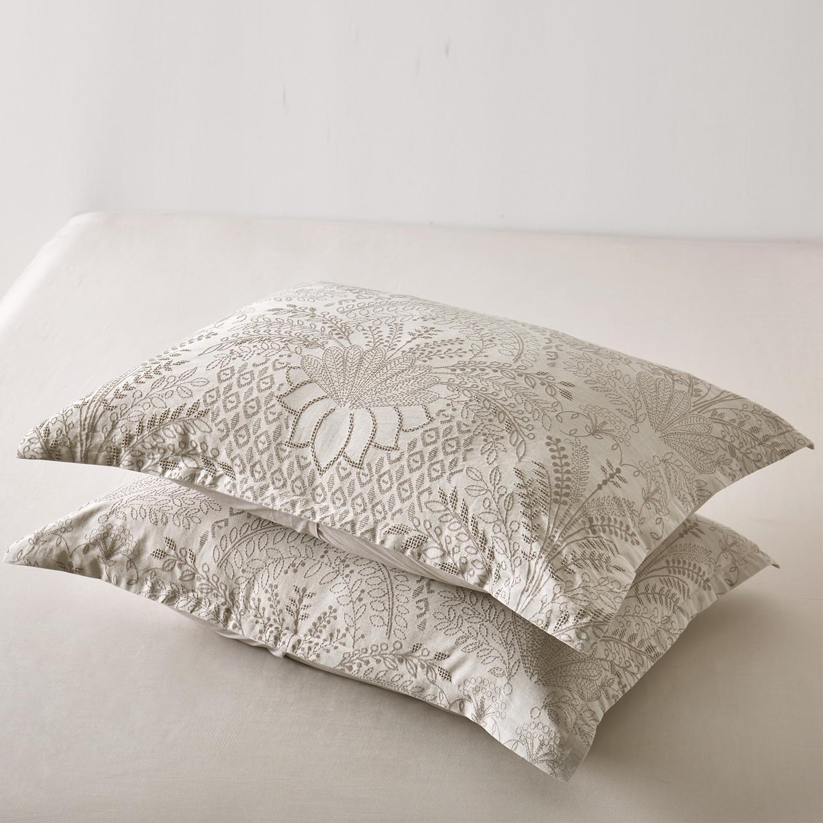 Two Timeless Heritage Woven Comforter Set pillows on a white sofa