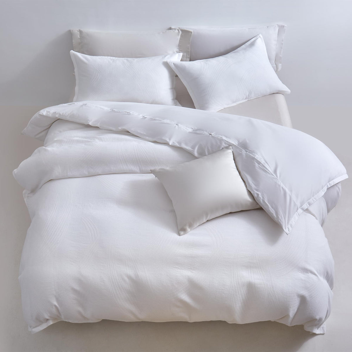 White Aurora Bloom Leaf Jacquard Duvet Cover Set White with duvet and pillows on a light gray background