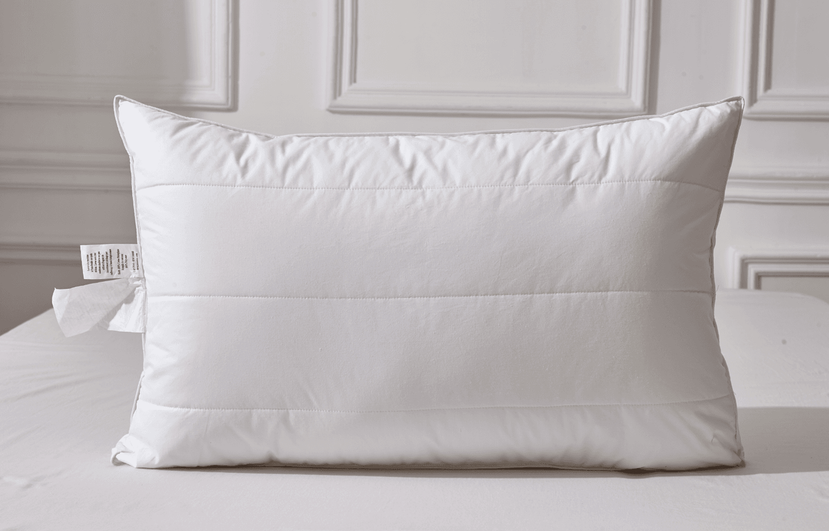 White Organic Cotton White Pillow on a bed with a neutral background