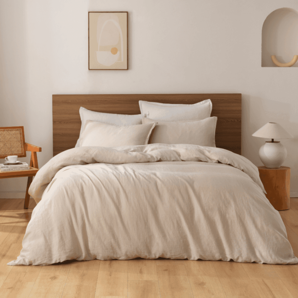 Neatly made bed with beige European Flax Linen Duvet Cover in a bedroom setting.