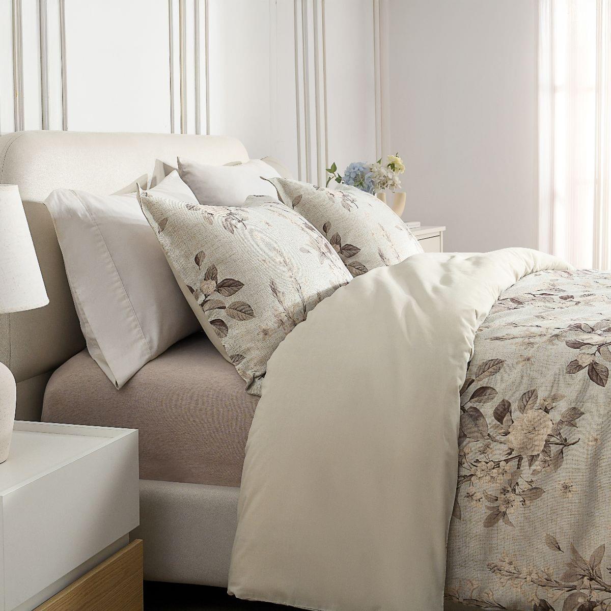 Neatly made bed with Floral Bouquet Comforter Set in a bedroom setting