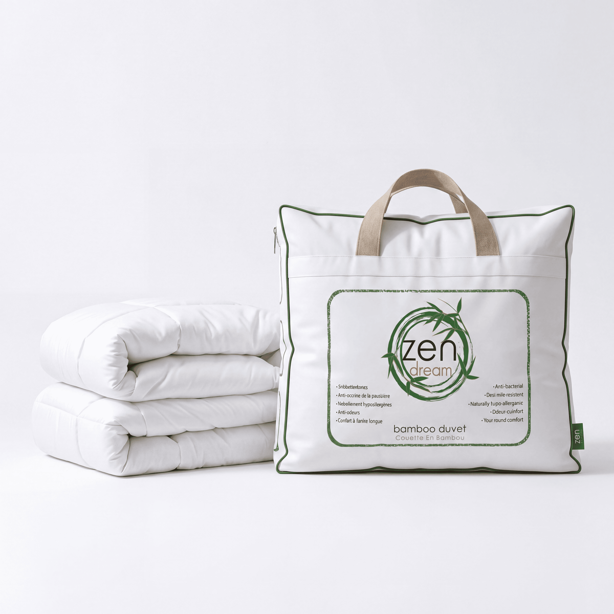 A folded white All Season Bamboo Duvet White Insert next to its white storage bag with green trim and tan handles. The bag features a large front label with the brand name 'zen dream' and product details, set against a clean white background.