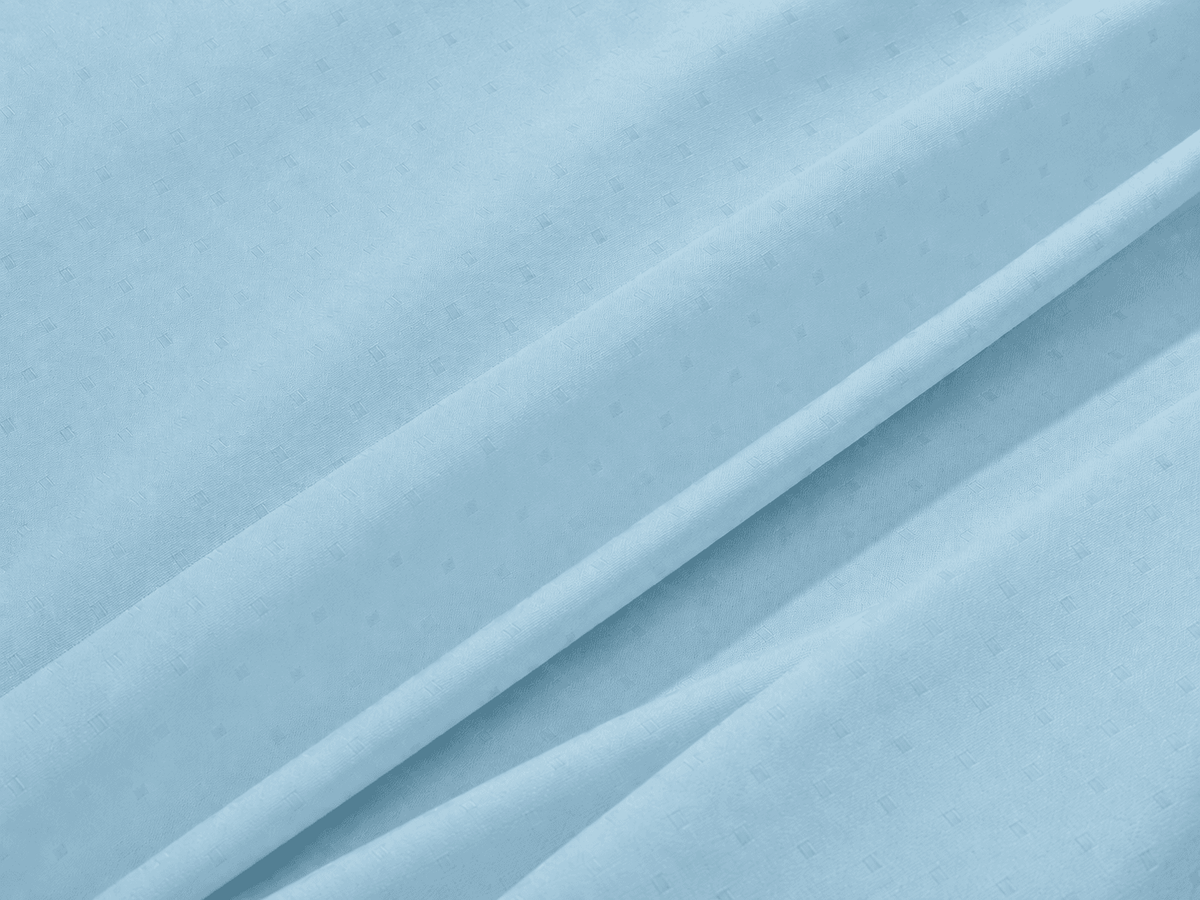 Close-up of light blue 600 Thread Count Jacquard Swiss Dot 100% Cotton Sheet Set with folds