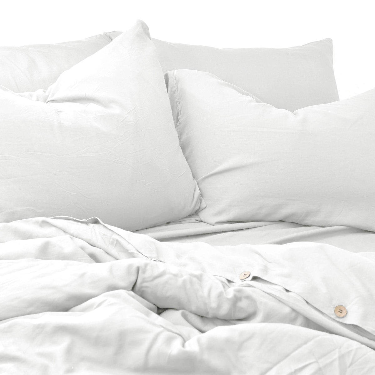 White bedding set with pillows on a white background