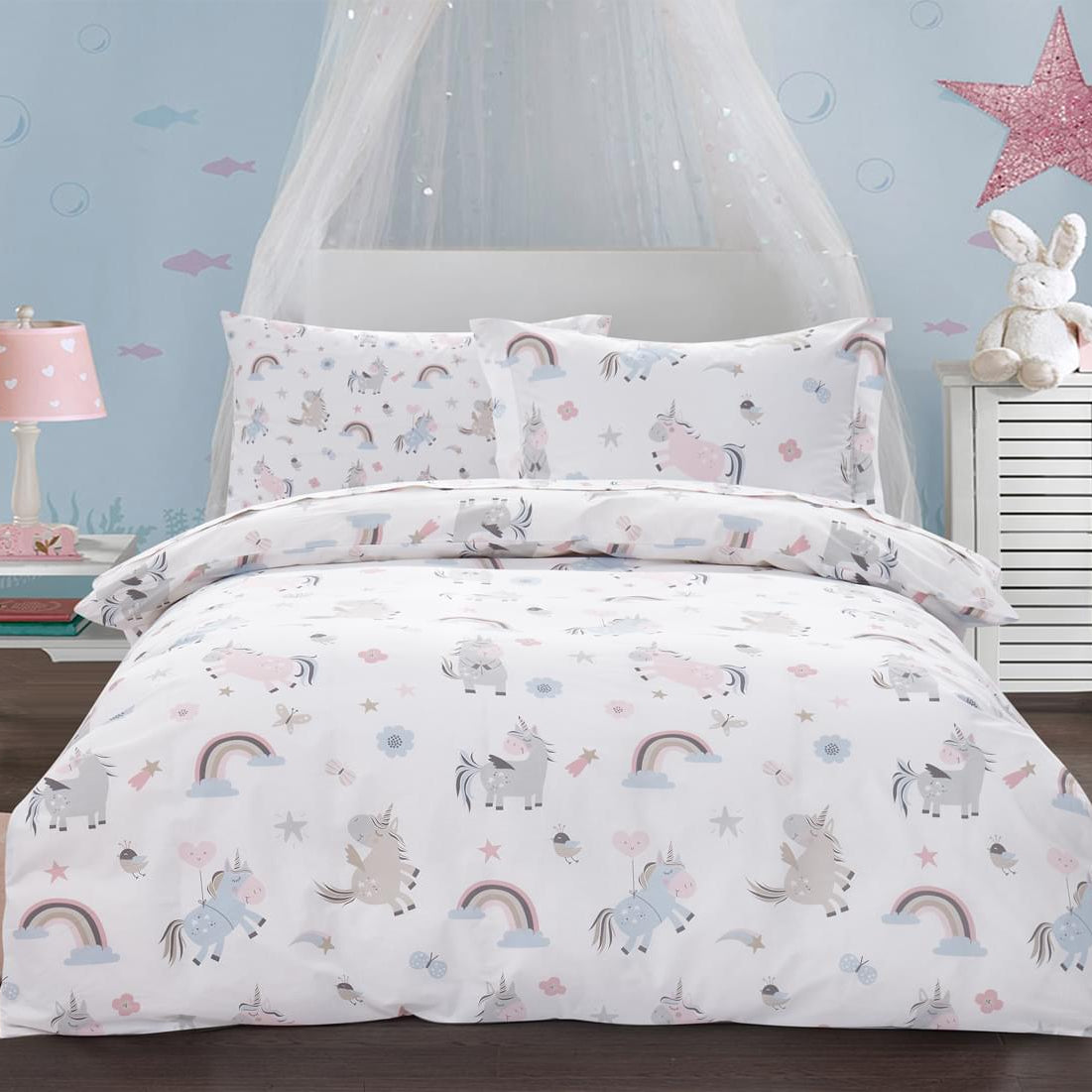 Children's bedroom with Organic Cotton Printed Unicorn Duvet Cover Set on a bed, light blue wall with decorative elements.