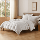 Neatly made bed with white European Flax Linen Duvet Cover in a bright bedroom