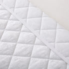 Close-up of a Timeless Heritage Woven Quilt Set White with a diamond pattern.