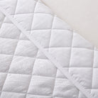 Close-up of a white Aurora Bloom Leaf Jacquard Quilt Set White on a plain background