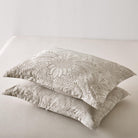Two Timeless Heritage Woven Comforter Set pillows on a white sofa