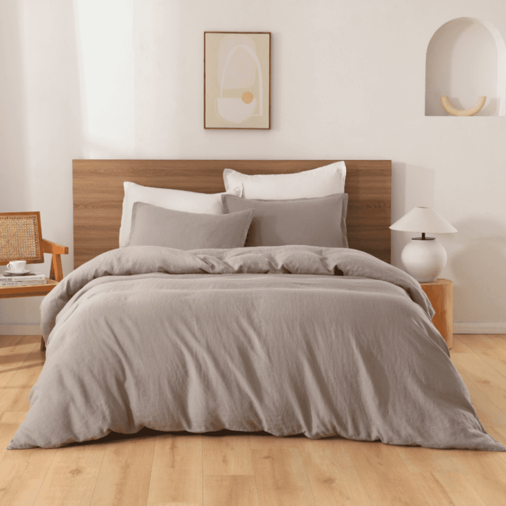 Neatly made bed with gray European Flax Linen Duvet Cover in a bedroom setting.