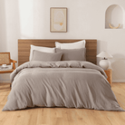 Neatly made bed with gray European Flax Linen Duvet Cover in a bedroom setting.