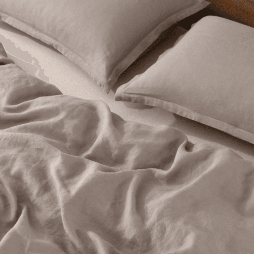 Close-up of beige bedding with pillows on a bed