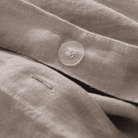 Close-up of beige fabric with a button