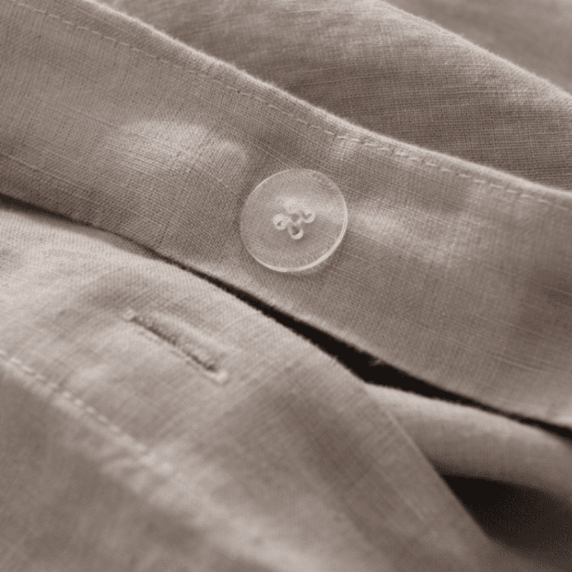 Close-up of beige fabric with a button
