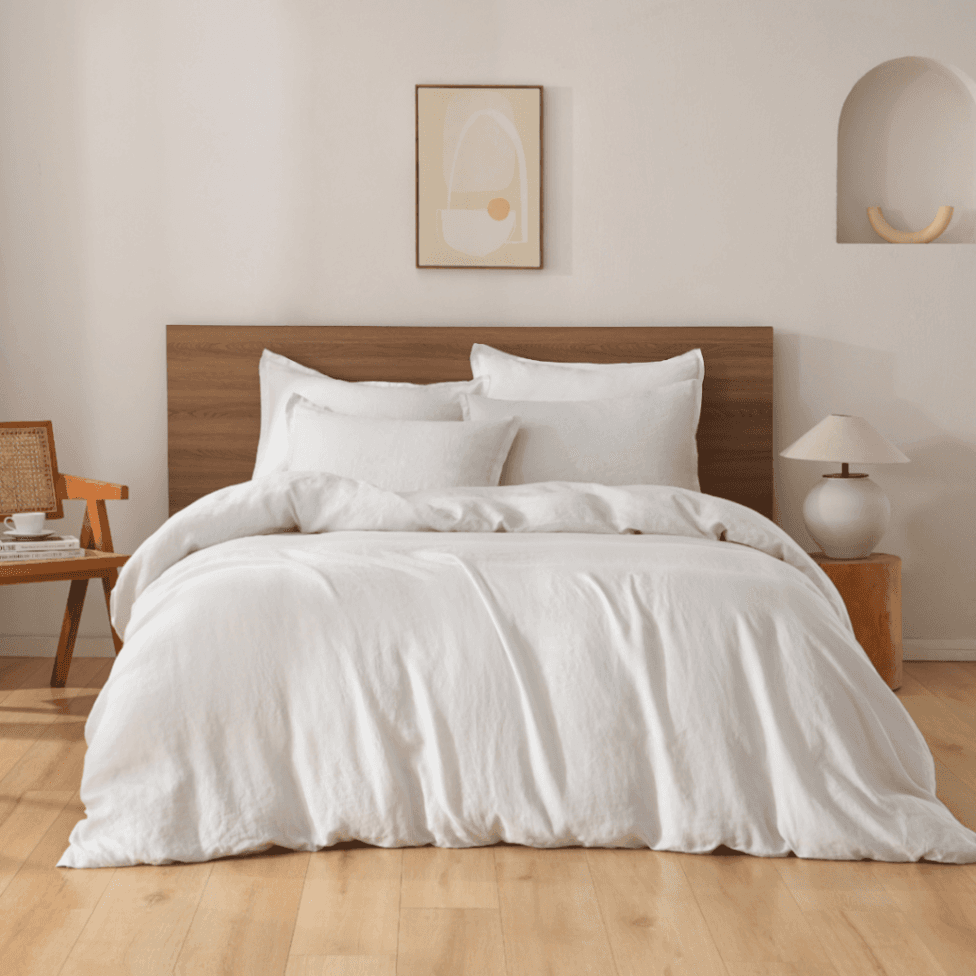 Neatly made bed with white European Flax Linen Duvet Cover in a bedroom setting.
