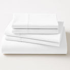 Stack of white folded sheets on a light gray background