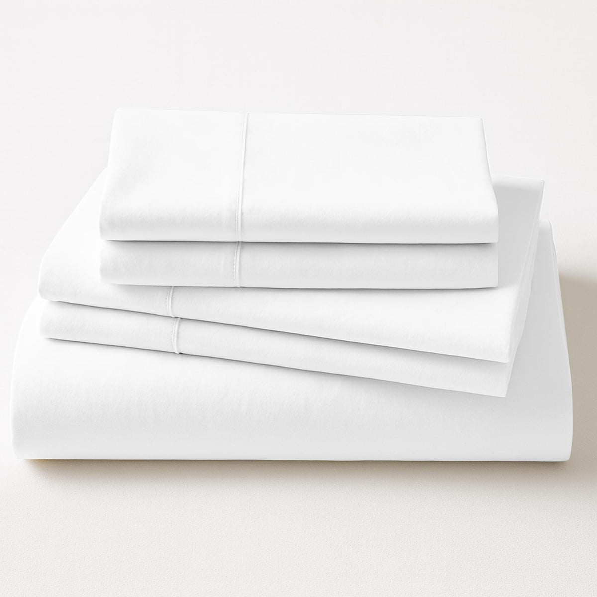 Stack of white folded sheets on a light gray background