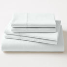 Stack of light gray bed sheets on a white background