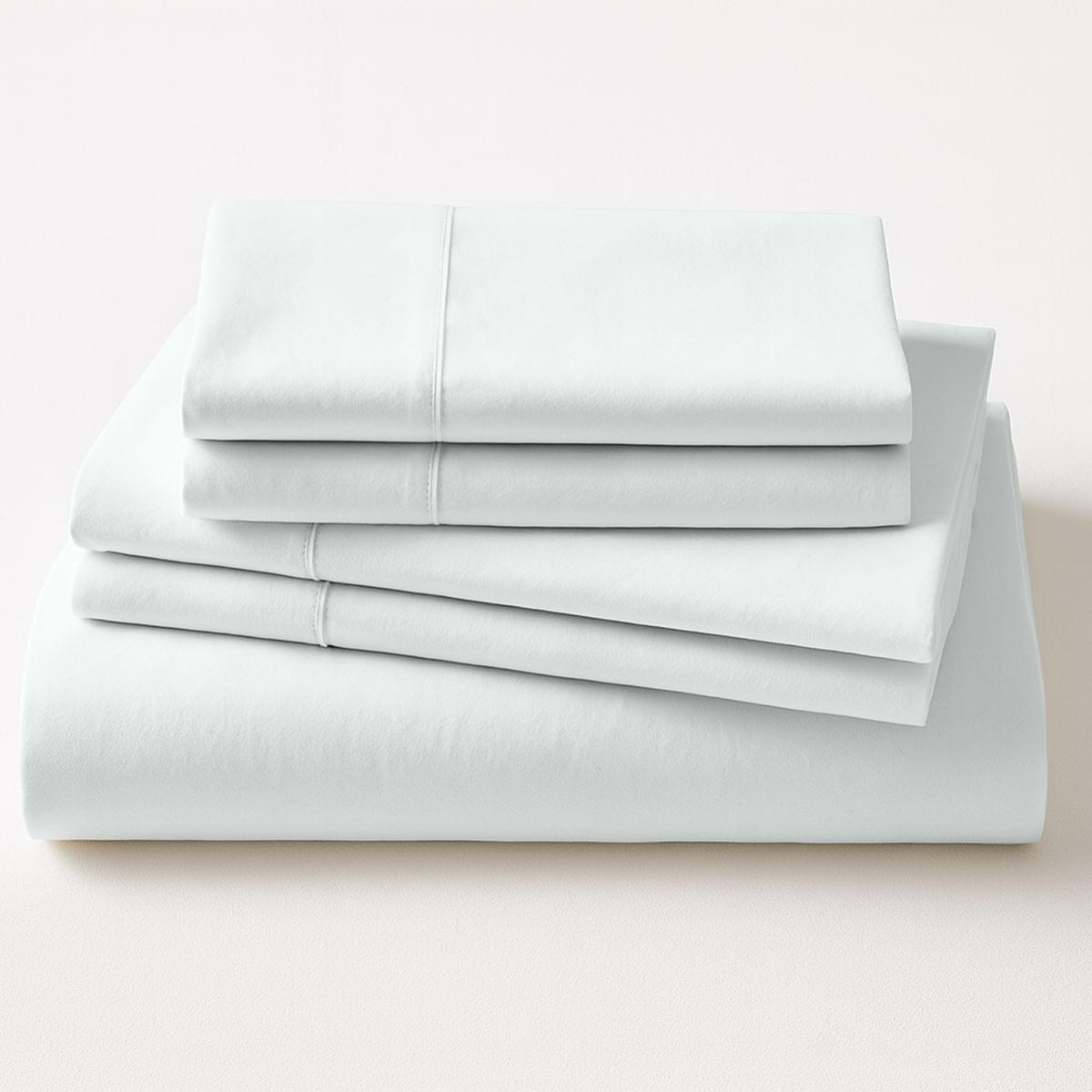Stack of light gray bed sheets on a white background