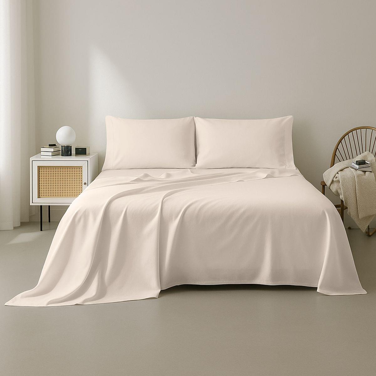 Beige bedding set on a bed in a minimalistic bedroom setting