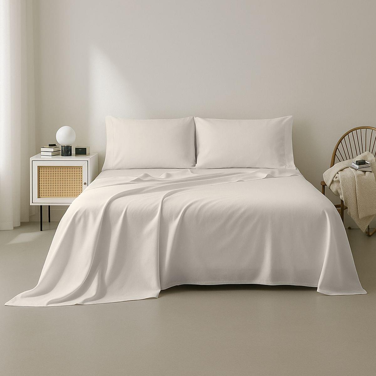 Neatly made bed with white bedding in a minimalistic bedroom setting.
