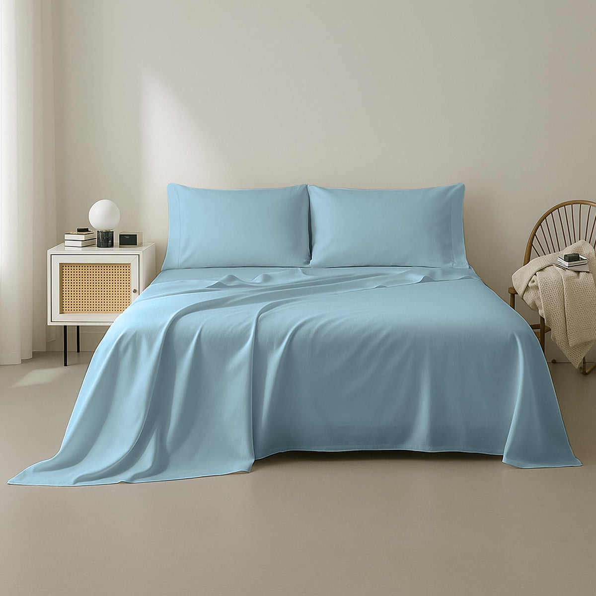 Light blue bedding set on a bed in a minimalistic bedroom.
