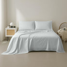 White Organic Cotton Sheet Set 400 Thread Count on a bed in a minimalistic bedroom setting