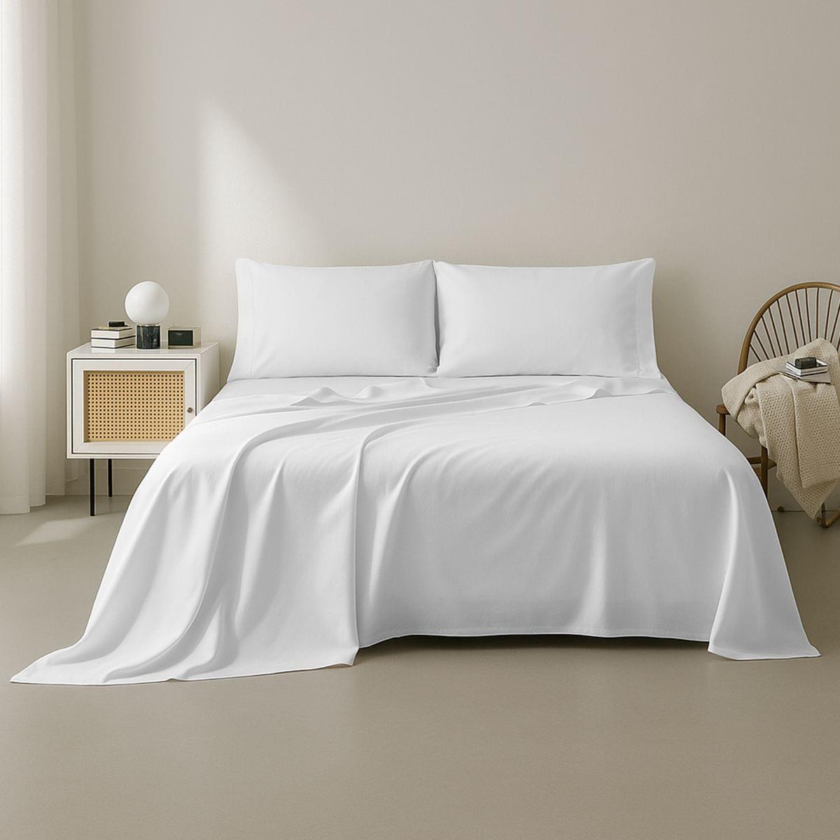 White 100% Cotton Sheet Set 400 Thread Count set on a bed in a minimalistic bedroom setting
