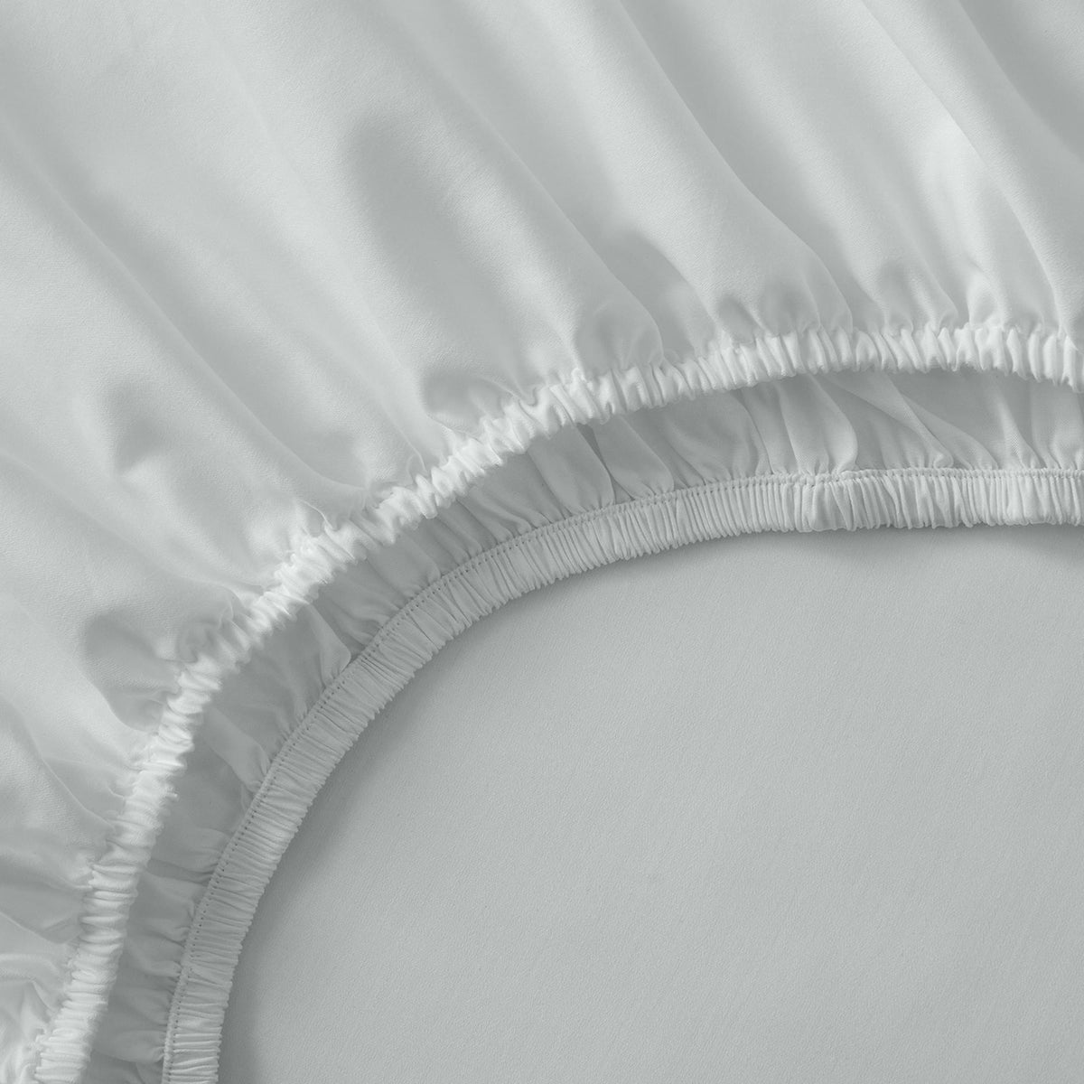 Close-up of a white fitted Organic Cotton Sheet Set 400 Thread Count on a bed