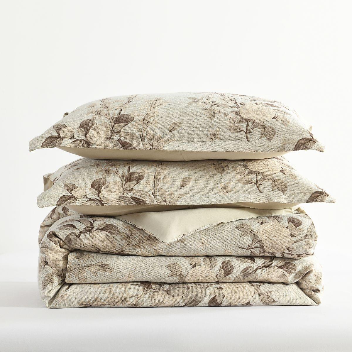 Stack of floral-patterned bedding on a white background