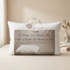 White Down Alternative Gel Microfiber Pillow with packaging on a bed in a bedroom setting