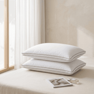 Two white Down Alternative Gel Microfiber Pillow stacked on a bed with a window in the background