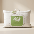 White pillow with green label on a beige background