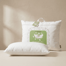 Two white Down and Feather Pillow with a green tag on a beige background