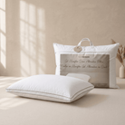White Down Alternative Gel Microfiber Pillow on a bed with packaging in the background