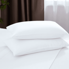 White pillows on a bed with a neutral background