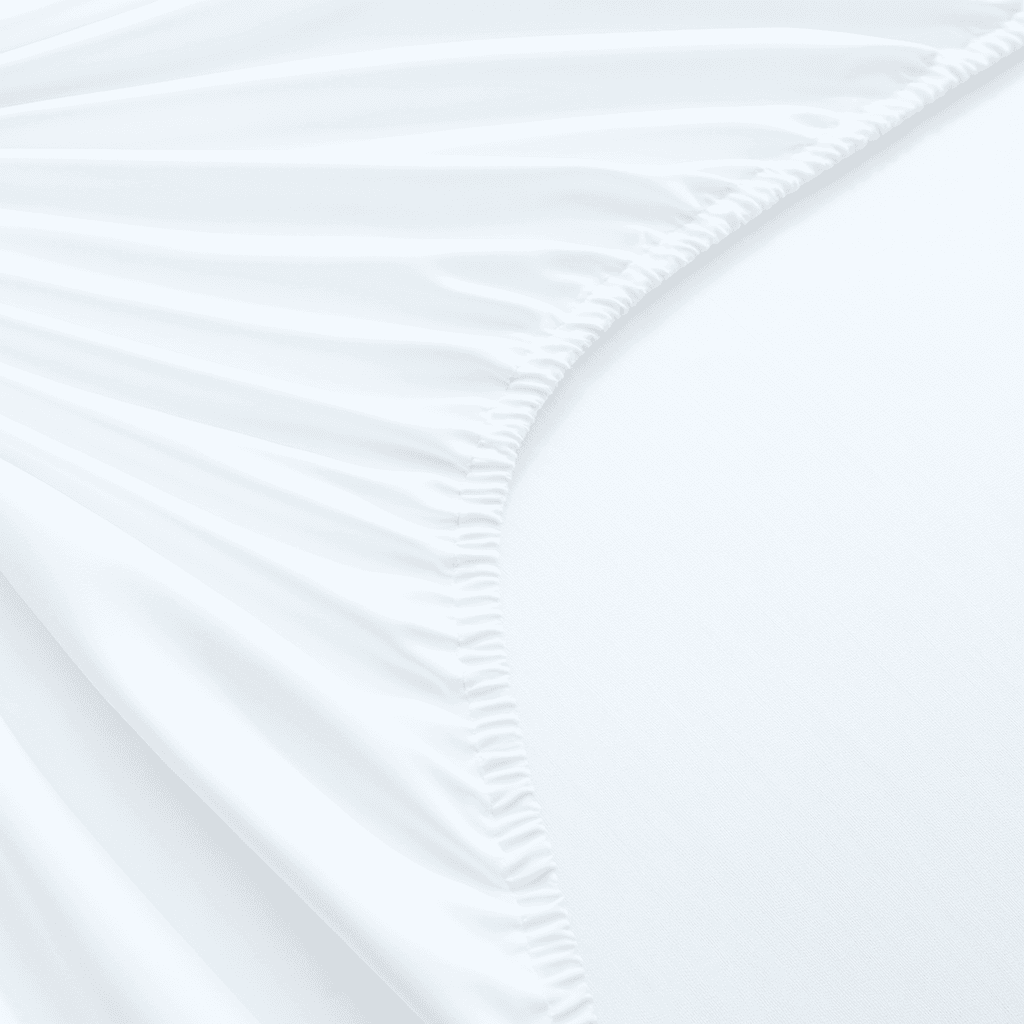 Close-up of white fitted sheet with subtle texture on a bed.