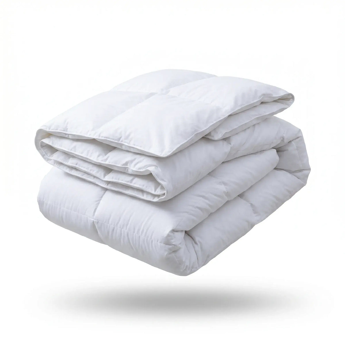 A folded white quilted comforter or duvet shown floating against a clean white background with a soft shadow underneath.