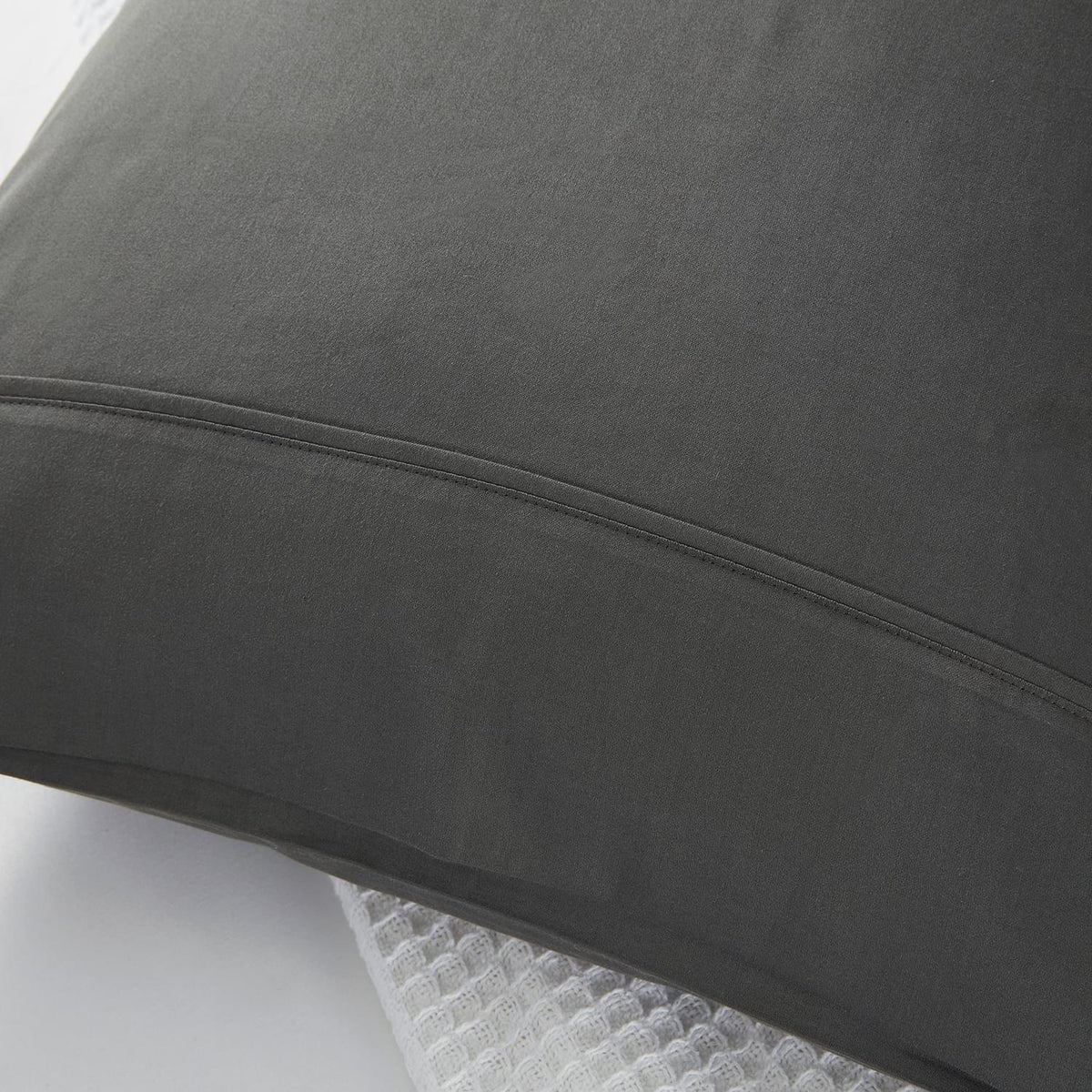 Close-up of a dark gray Classic 500 Thread Count Organic Pillowcase Pair on a white background