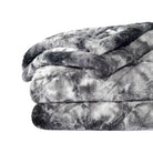 Folded camouflage-patterned Hug Me Faux Weighted Throw Blanket on a white background