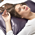 Woman lying on a purple Hug Me Silk Pillowcase with a soft-focus background