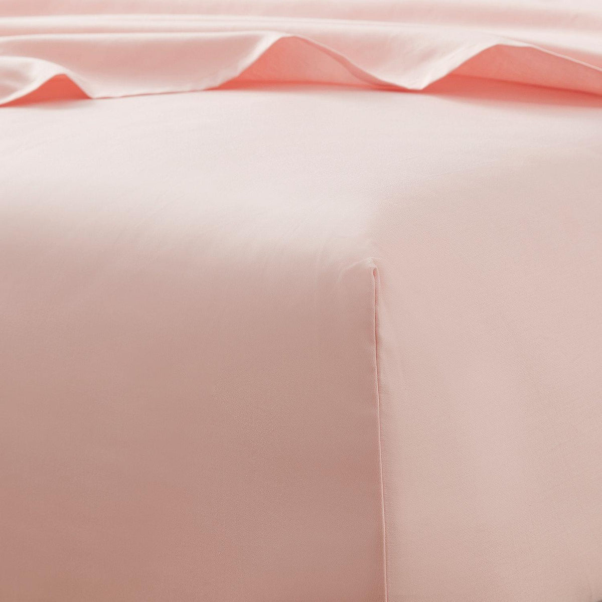 Close-up of pink satin fabric with a subtle pattern