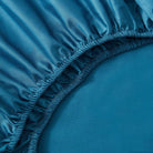 Close-up of a blue fitted sheet on a bed