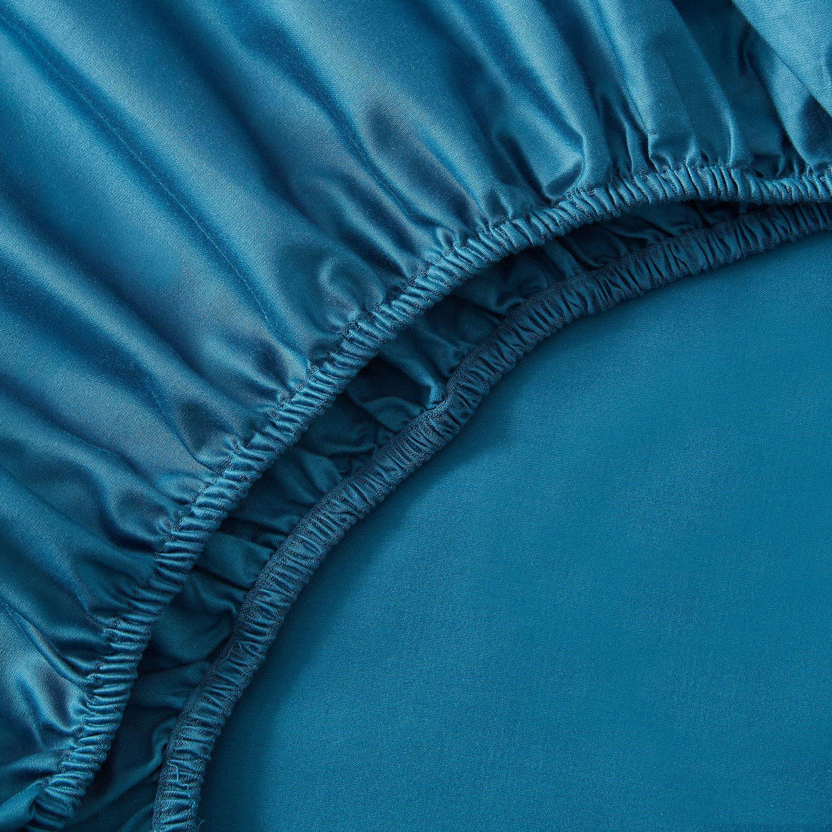 Close-up of a blue fitted sheet on a bed
