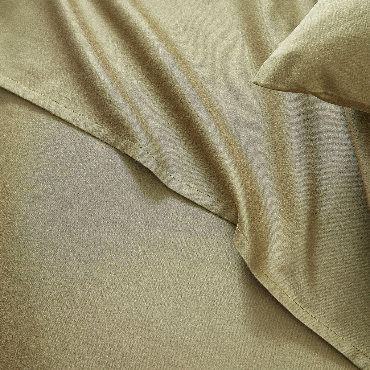 Close-up of beige bedding with a pillow