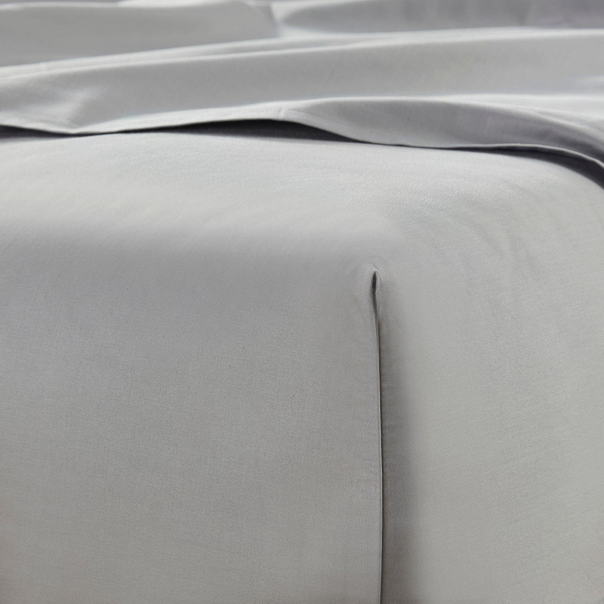 Close-up of gray bedding with a subtle pattern