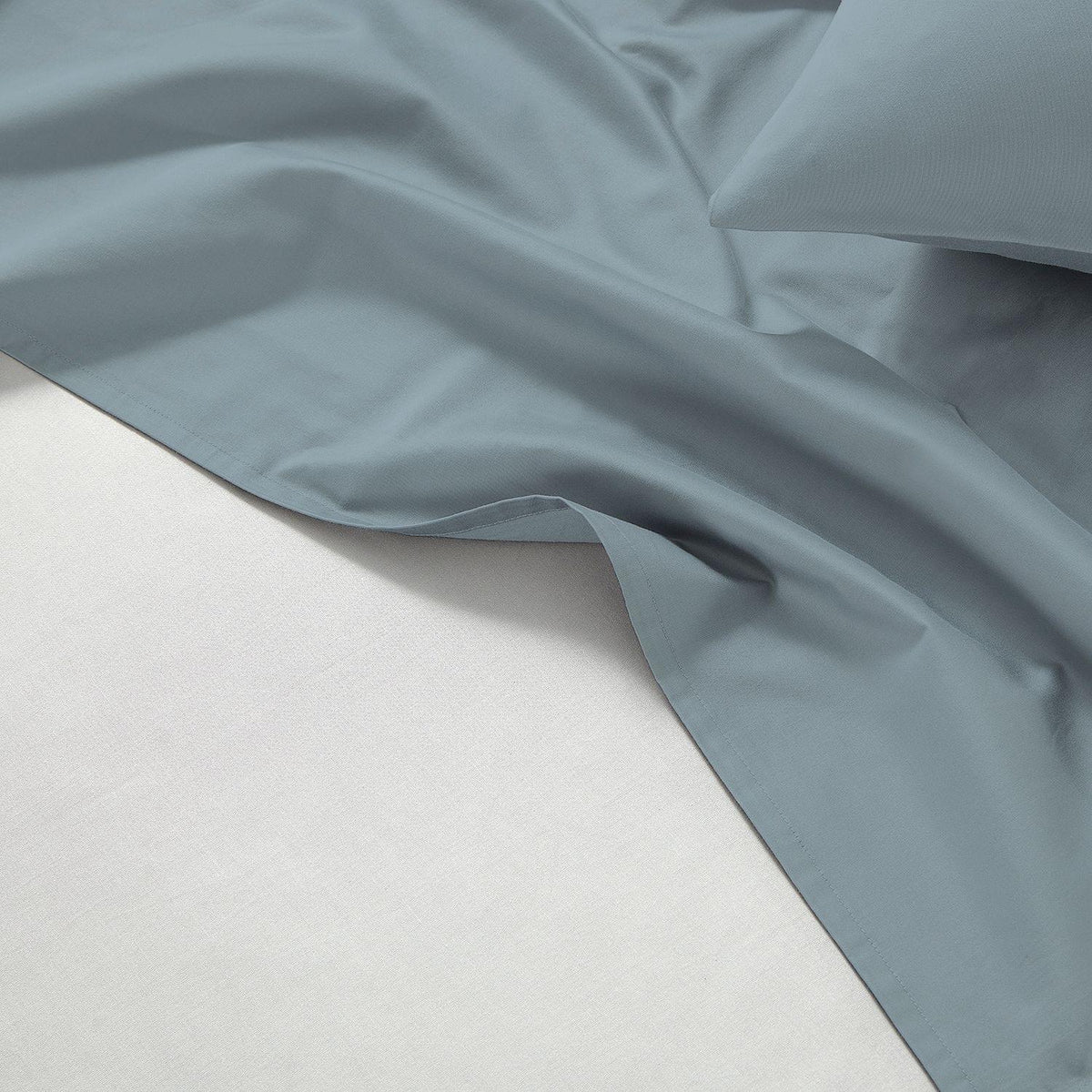 Gray fabric draped over a white surface